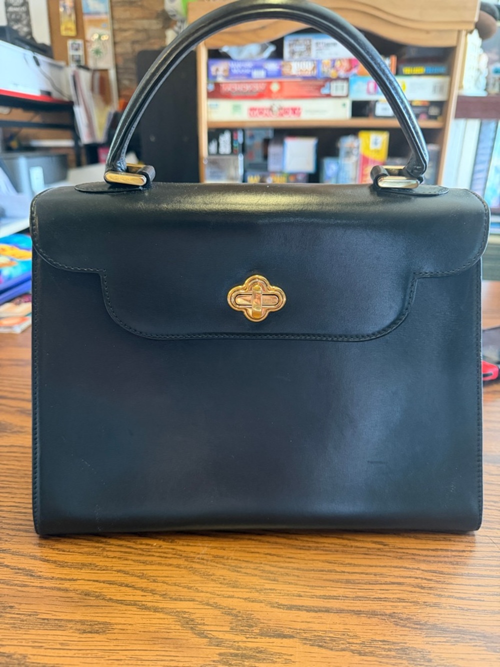 Vintage Bally black leather handbag with gold-tone turn-lock closure.